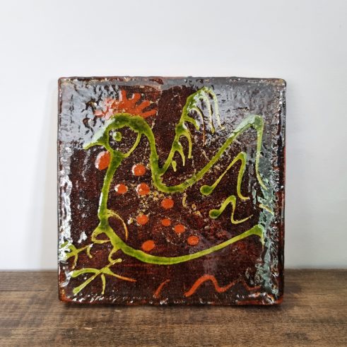 glazed earthenware tile with slip decoration featuring a chicken by Clive Bowen