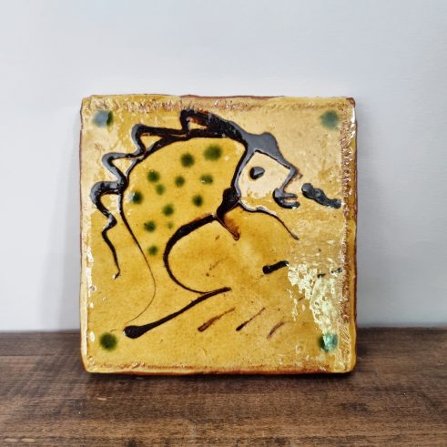 glazed earthenware tile with slip decoration featuring a fish by Clive Bowen