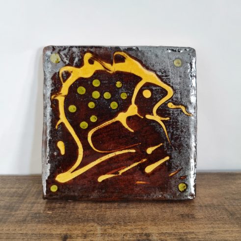glazed earthenware tile with slip decoration featuring a fish by Clive Bowen