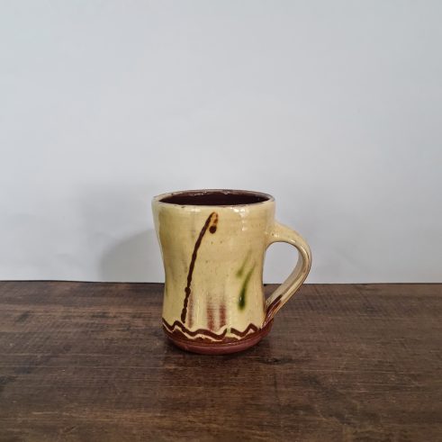 glazed earthenware meg with slip decoration