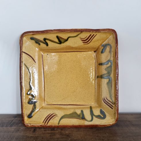 glazed earthenware dish with slip decoration by Clive Bowen