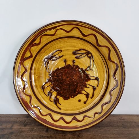 glazed earthenware platter with slip decoration featuring a crab by Clive Bowen