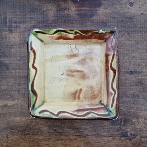 glazed earthenware square dish with slip decoration by Clive Bowen