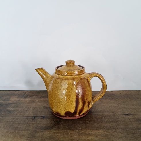 glazed earthenware teapot with slip decoration