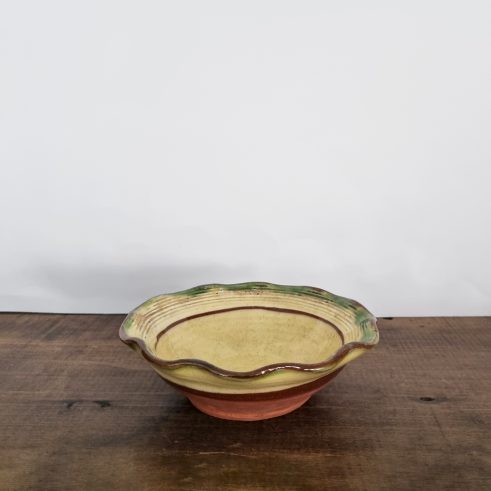 small glazed earthenware wavy bowl with slip decoration by Clive Bowen