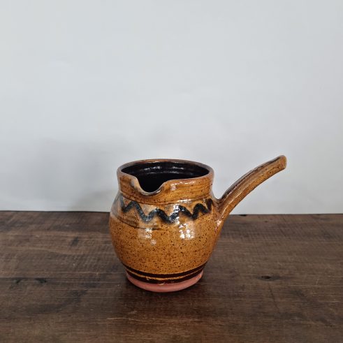 glazed earthenware handled jug with slip decoration by Clive Bowen