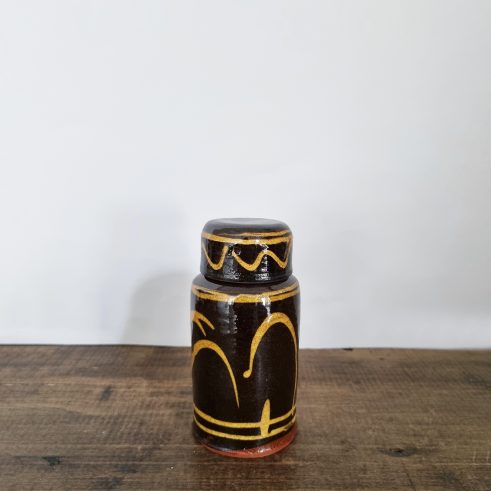 small glazed earthenware lidded jar with slip decoration By Clive Bowen
