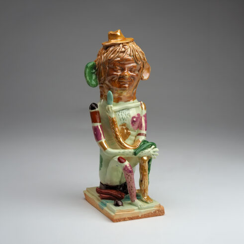 Sitting Man With A Green Rag And Pipe
