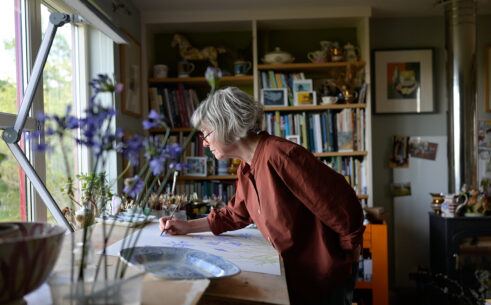 Angie Lewin painting in her studio I, 2026